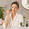 Woman using gua sha jade roller for facial massage and skin rejuvenation