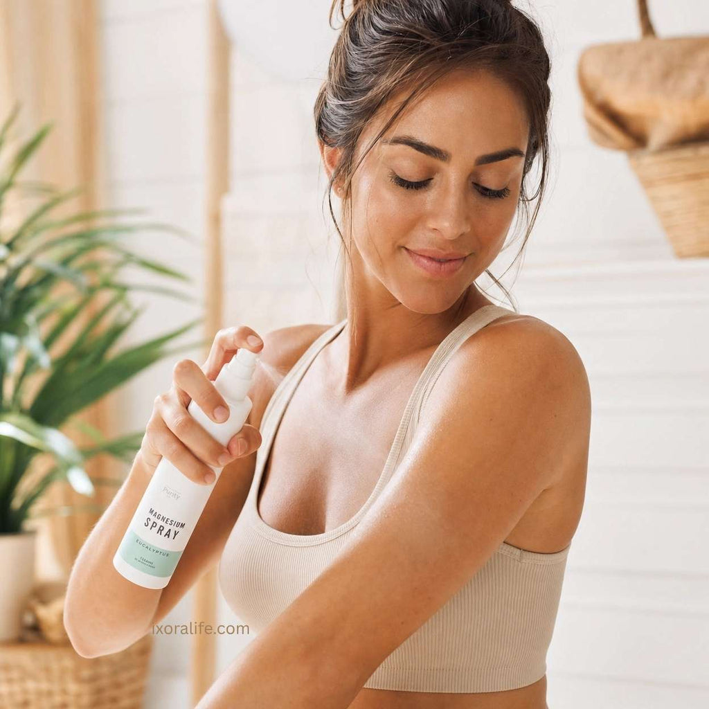 Woman applying magnesium spray for muscle relaxation